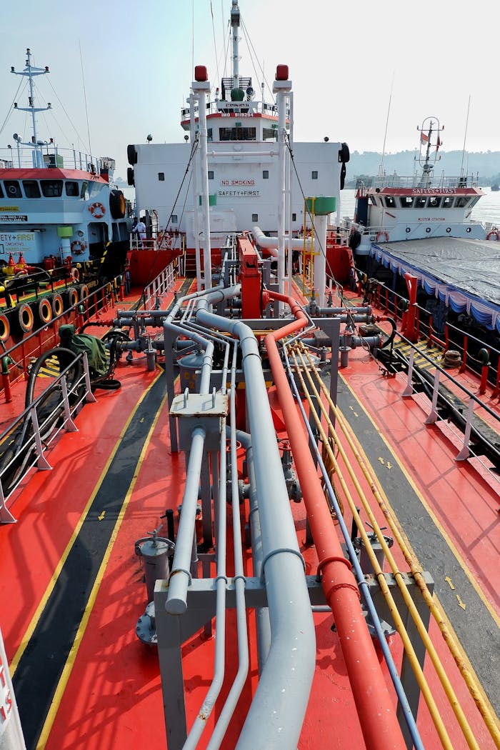 A detailed view of a shipping tanker's deck and pipeline system docked in Banten, Indonesia.